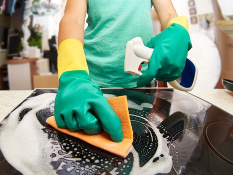 Local office cleaners in Twickenham vacuuming a modern workspace